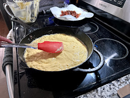 Pancake batter spread in skillet