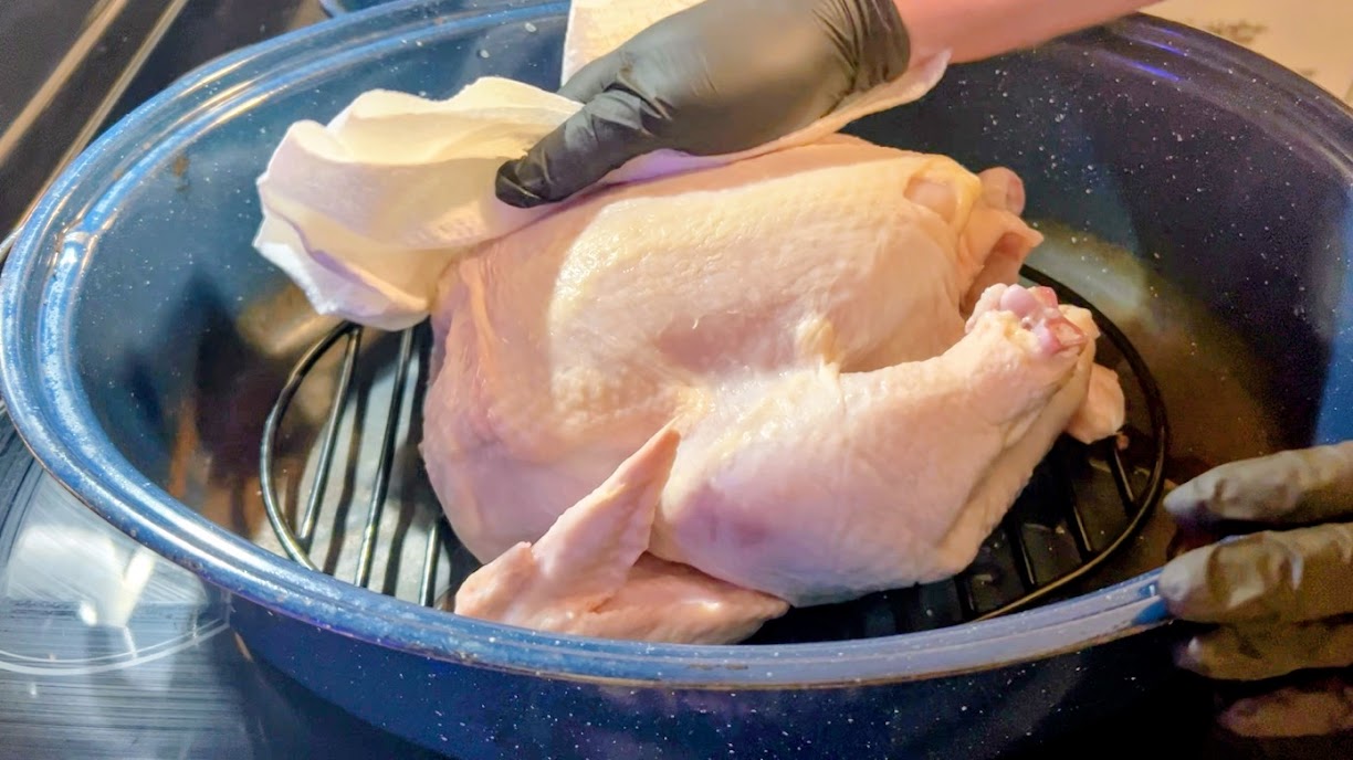 Whole chicken patted dry in roasting pan